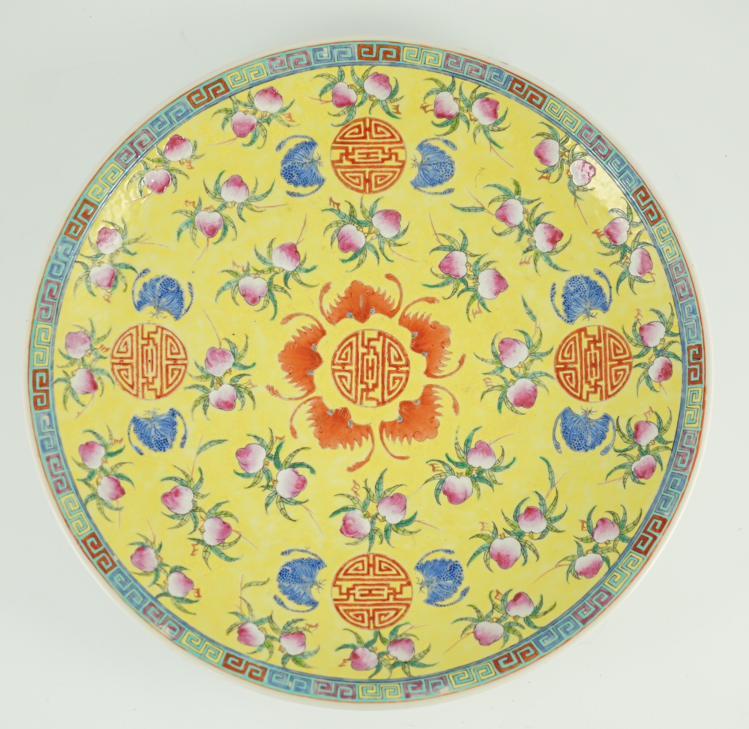 A Chinese yellow ground ‘peaches and bats’ dish, Republic period, 32.7cm diameter, hairline crack to rim